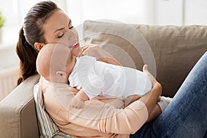 Happy mother with little baby boy at home