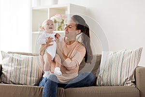 Happy mother with little baby boy at home