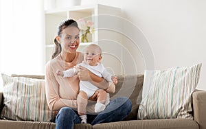 Happy mother with little baby boy at home