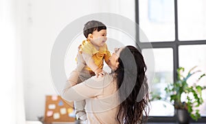 Happy mother with little baby son at home