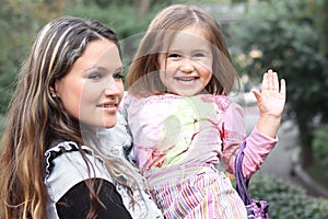 Happy mother and little daughter on a walk