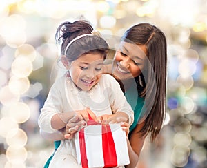 Happy mother and little girl with gift box