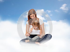 Happy mother and little girl with tablet pc
