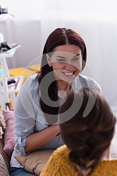 happy mother looking at teenage daughter