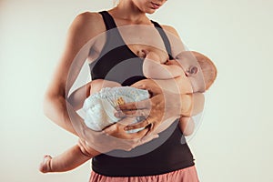 Happy mother with newborn baby infant on hands standing and breasfeeding lacting lactation health and care bonding time