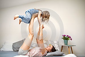 Happy mother playing with her daughter at home, mother`s day