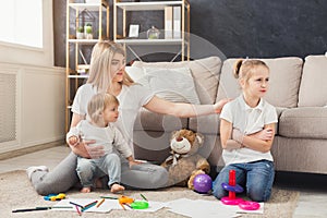 Happy mother playing with her daughters