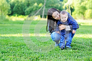 Happy mother playing with her son in the park