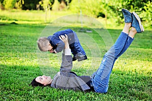 Happy mother playing with her son in the park