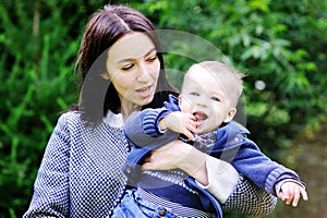 Happy mother playing with her son in the park