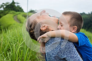 Happy mother playing with her son in the park