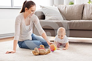 happy mother playing with little baby at home