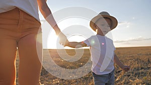 Happy mother playing with little son at sunset. Young caucasian mom and baby boy having fun outdoor in evening.