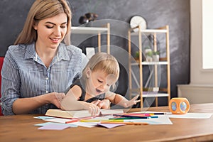 Happy mother reading with her daughter