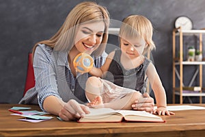 Happy mother reading with her daughter