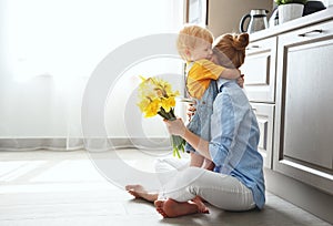 Happy mother`s day! baby son gives flowersfor mother on holiday