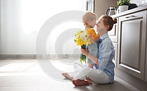 Happy mother`s day! baby son gives flowersfor mother on holiday