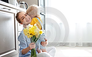 Happy mother`s day! baby son gives flowersfor mother on holiday