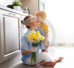 Happy mother`s day! baby son gives flowersfor mother on holiday