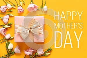 Happy Mother`s Day Background. Bright Yellow and Pastel Pink Colored Mother Day Background. Flat lay greeting card with gift box.