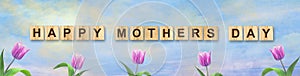 Happy Mother`s Day. Beautiful tulips against a cloudy sky. Greeting card. Festive banner