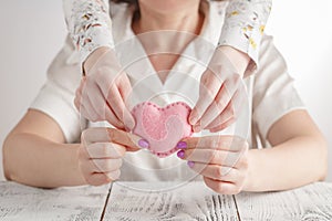 Happy mother`s day! Child daughter congratulates mom and gives her heart