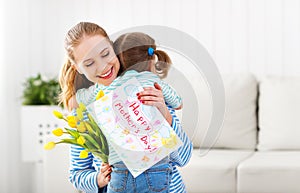 Happy mother`s day! Child daughter congratulates moms and gives