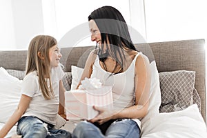 A Happy mother`s day. Child daughter congratulates moms and gives her a gift