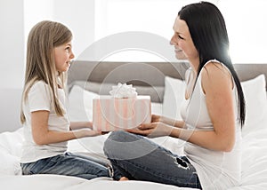 A Happy mother`s day. Child daughter congratulates moms and gives her a gift