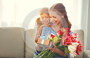 Happy mother`s day! child daughter gives mother a bouquet of f photo