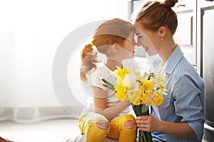 Happy mother`s day! child daughter gives mother a bouquet of f