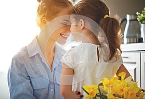 Happy mother`s day! child daughter gives mother a bouquet of f