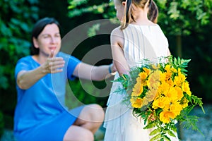 Happy mother`s day! Child girl congratulates mom and gives her b