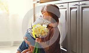 Happy mother`s day! child son gives flowersfor  mother on holiday