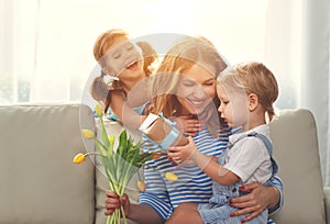 Happy mother`s day! Children congratulates moms and gives her a