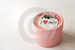 Happy mother`s day concept. Gift box and flower, paper tag with I LOVE MOM text