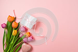 Happy Mother\'s day concept with tulip flowers, heart shape and gift box on pink background. Top view.
