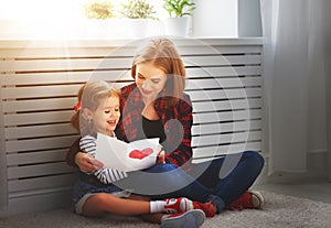 Happy mother`s day! Daughter gives her mother an postcard