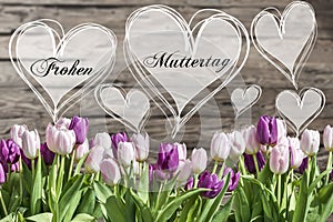 Happy mother`s day german text heart with pink and white tulips rustic wooden background greeting card spring flowers