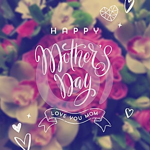 Happy mother`s day - Greeting card. Brush calligraphy greeting and hand drawn hearts on a blurred flowers background.