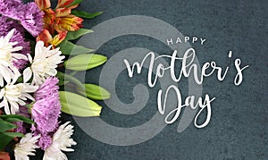 Happy Mother`s Day greeting holiday script over dark blackboard background texture