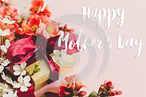 Happy mother`s day. Happy mothers day text and gift box with red and white flowers on pink background. Stylish floral greeting