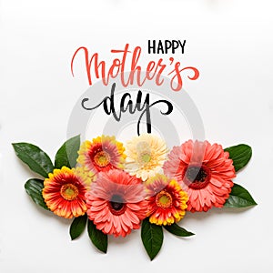 Happy Mother`s Day Living Coral Pantone Color Background. Coral flat lay greeting card with beautiful gerbera flowers.