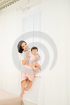 Happy mother`s day! Mom and her daughter child girl are playing, smiling and hugging