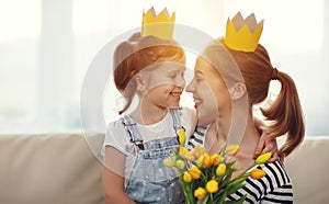 Happy mother`s day! mother and child daughter in crowns and with