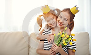 Happy mother`s day! mother and child daughter in crowns and with