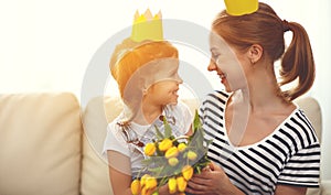 Happy mother`s day! mother and child daughter in crowns and with
