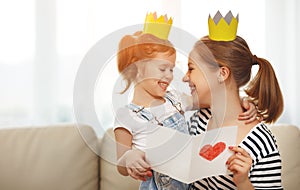 Happy mother`s day! mother and daughter in crowns and with po