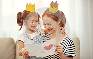 Happy mother`s day! mother and daughter in crowns and with po