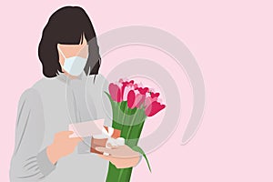 Happy Mother`s day in quarantine. Woman in face mask with greeting card and tulips bouquet on pink background, healthy receiving